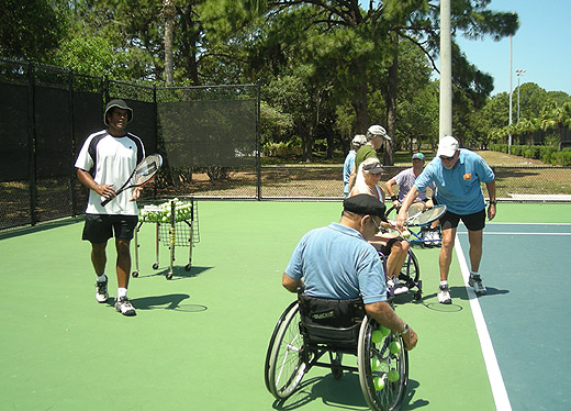 Robert teaching handicapped tennis.